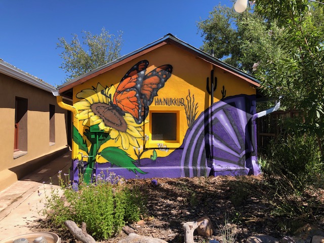 Daytime mural with a monarch butterfly on a sunflower